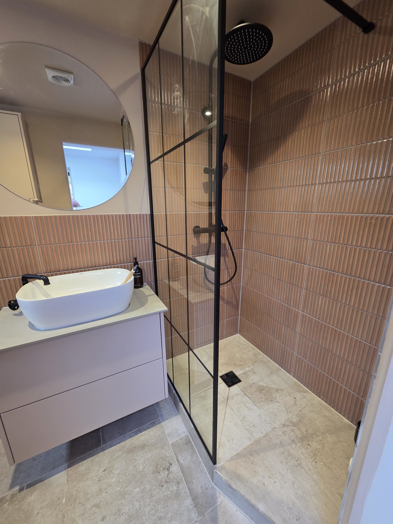 Modern bathroom with terracotta finger tiles and matte black fittings