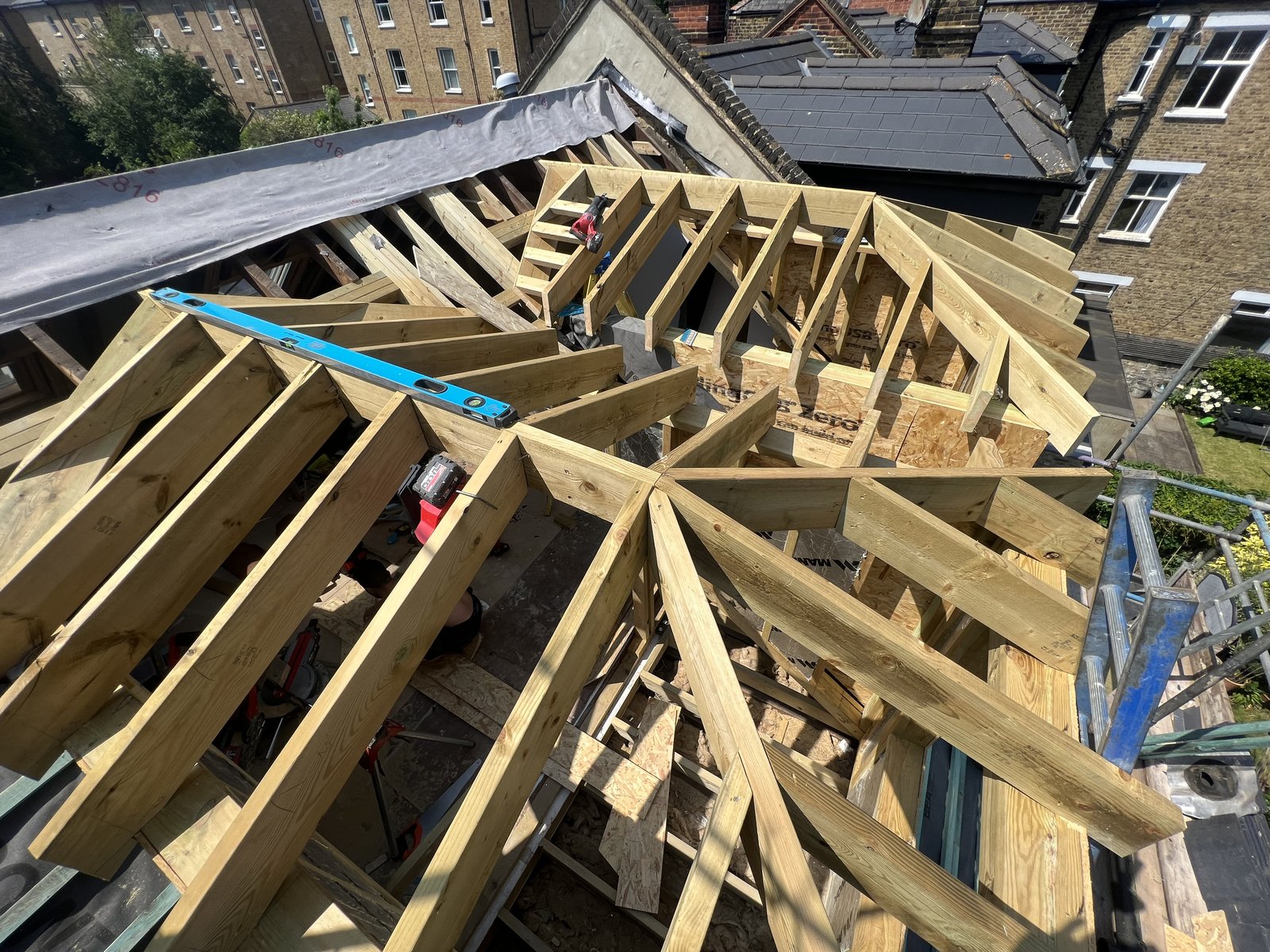 Timber roof framing on site, with hips and valleys set out in the rafters