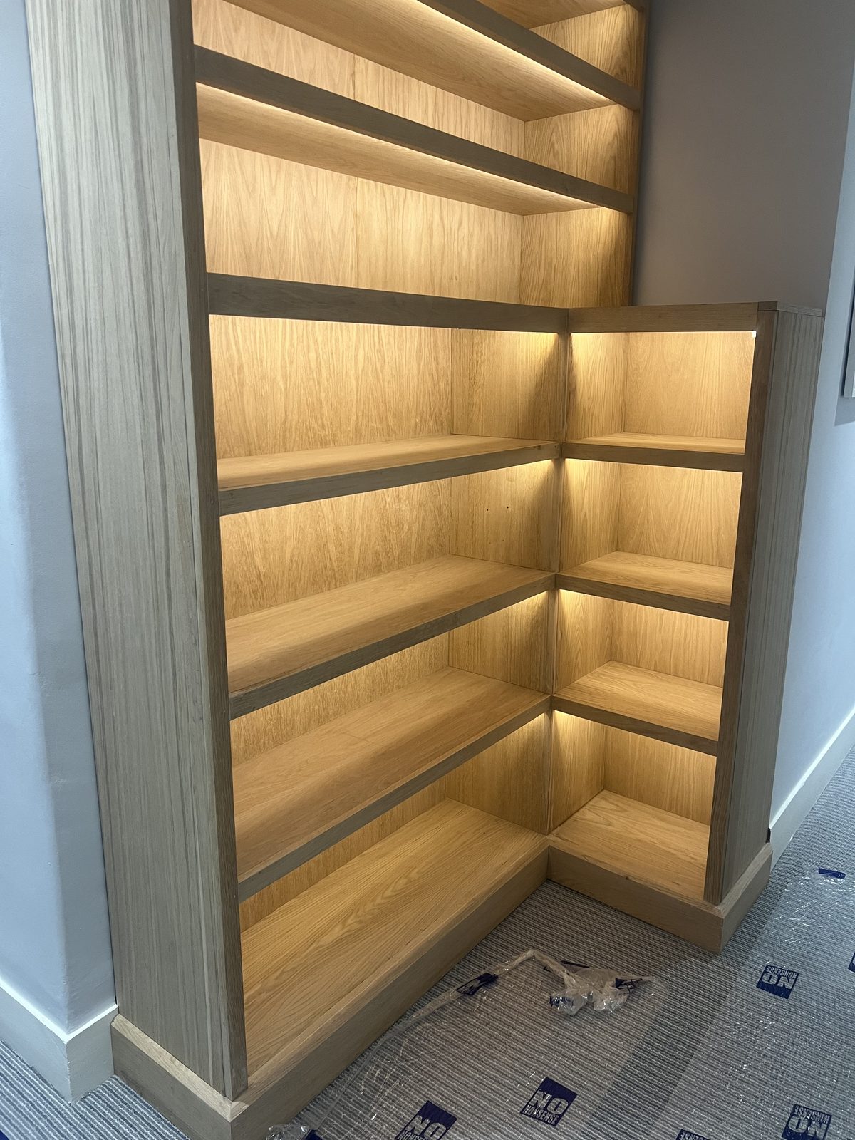 Custom oak bookcase with warm integrated LED lighting